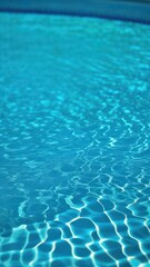 Obraz premium Close view of clear beautiful blue flowing water in swimming pool. Slow motion vertical video. Water surface. Travel and vacation concept. Summer