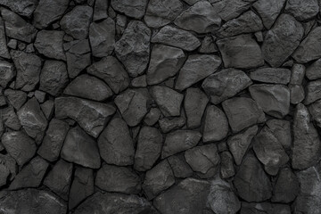 Old wall made of uneven natural stones. Abstract construction background.