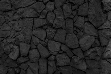Old wall made of uneven natural stones. Abstract construction background.