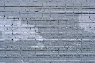 The old wall is unevenly painted. Abstract construction background.