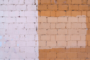 The old wall is unevenly painted. Abstract construction background.