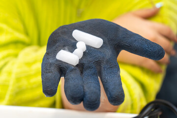 Pieces of dry ice held in a blue gloved hand