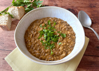 Traditional Indian Akkha Masoor Dal dish. Curry with red lentils.