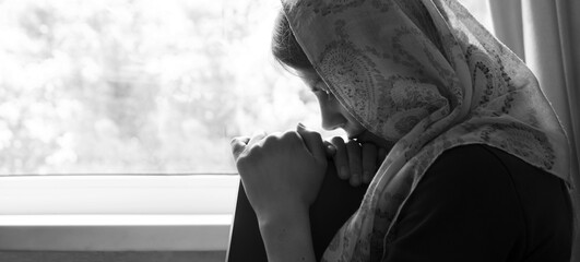 Girl with a book by the window