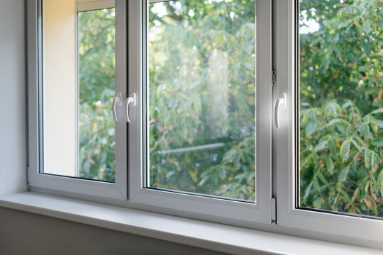 Fototapeta White window frame with modern aluminium profiles in bedroom
