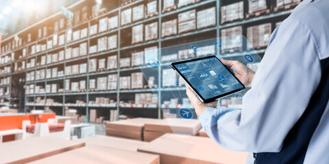 Business Logistics warehouse management system technology concept.Man hands using tablet on blurred...