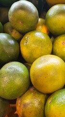 Close up pile of tasty fresh oranges sold at the market as a background.