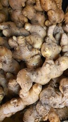 Close up pile of tasty fresh ginger sold at the market as a background.	
