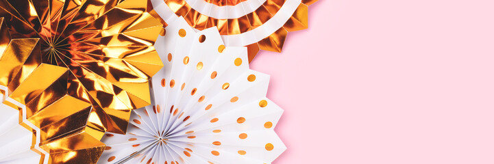 Banner with golden paper fans on a pink background with place for text.
