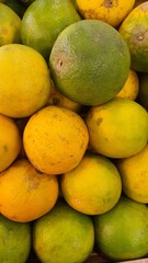 Close up pile of tasty fresh oranges sold at the market as a background.