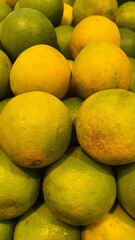 Close up pile of tasty fresh oranges sold at the market as a background.