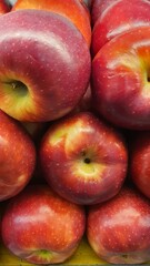 Close up pile of tasty fresh apples sold at the market as a background.