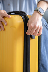 closing the yellow suitcase to go on a trip to work, enjoy and relax