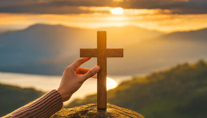open hand stretches toward a distant, blurred wooden cross in the sunset sky, symbolizing hope, faith, and longing