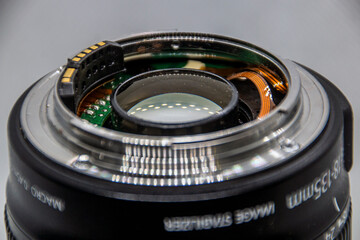 Chips and microcircuits in a camera lens close-up on a gray background	
