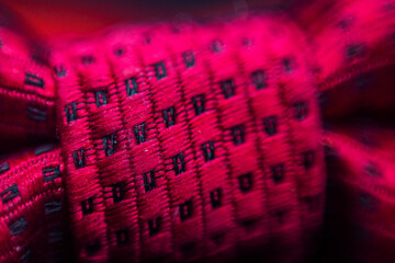 Red butterfly central knot with squares in macro	
