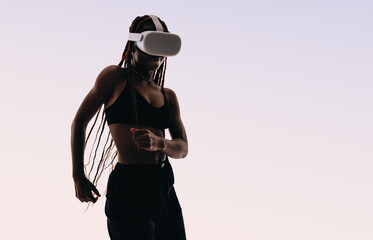 Confident woman dancing with immersive vr headset in studio