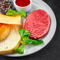 raw burger set cutlet, bun, cheese, tomato sauce, greens fresh cooking meal food snack on the table copy space food background 
