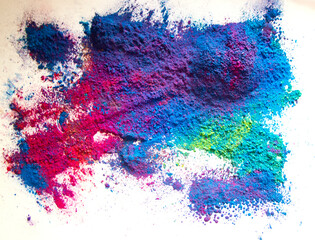 colored powder. shades of blue and red predominate, on a white background.