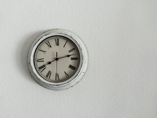 Wall retro clock on a white wall