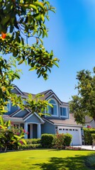 This showcases a lush green lawn in front of a two-story blue house with white accents and a two-car garage