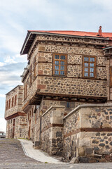 Tarihi Erzurum Tas Evleri or Traditional Erzurum stone houses on cobblestone street.