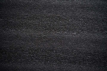 Black porous porous foam background. Background texture of black foam rubber