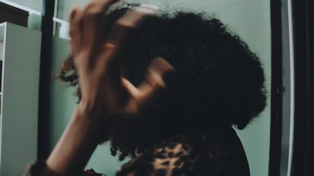 Close up of a woman twisting afro hair. Hair weaving