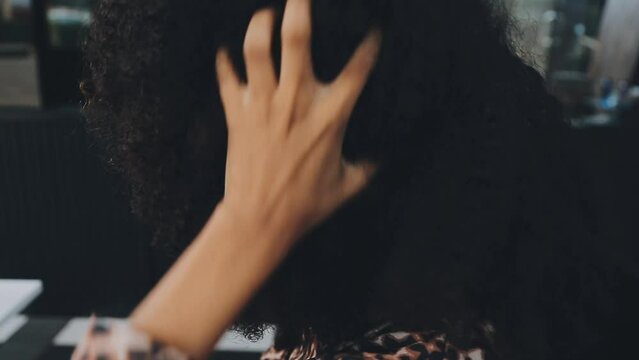 Close up of a woman twisting afro hair. Hair weaving