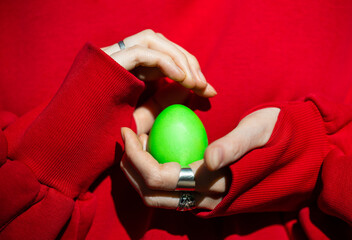 Enigmatic Encounter: A Person Holding a Green Egg