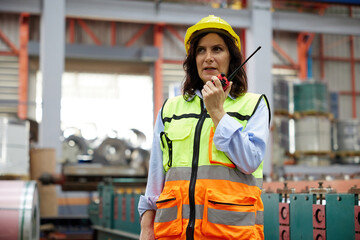 worker or engineer using walkie talkie and talking about work in the factory