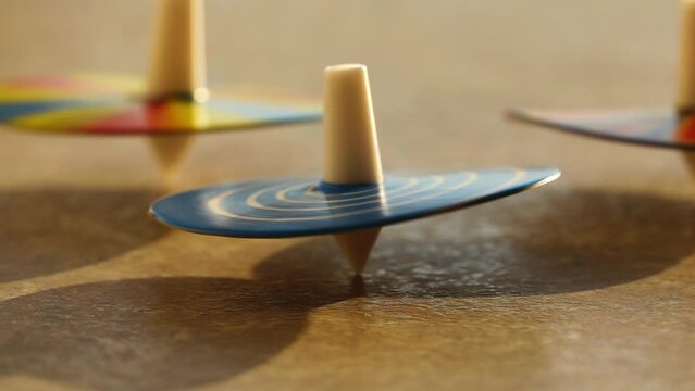 Several whirligigs spin around her own axis on the table.