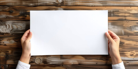 Hands Presenting Blank White Paper on Rustic Wooden Surface