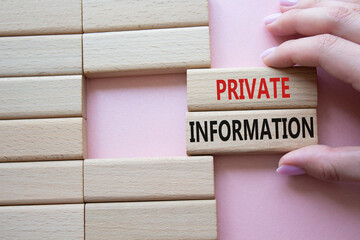 Private Information symbol. Wooden blocks with words Private Information. Beautiful pink...