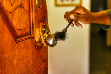 african american police detective collecting forensic evidence for fingerprints with a brush...