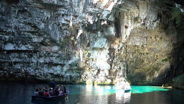 Zakynthos, Greece - September 25, 2022: Bunch of tourists on a boat in the famous melissani lake on Kefalonia island
