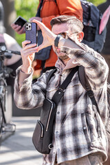 Modern gadgets. Phone in hands. Use a smartphone. City life. Communication method. Style of life. Stylish young people. Stay in touch. Social networks. Online business. Work remotely.