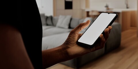 African-American Hand with smartphone in modern home, perfect for smart home app