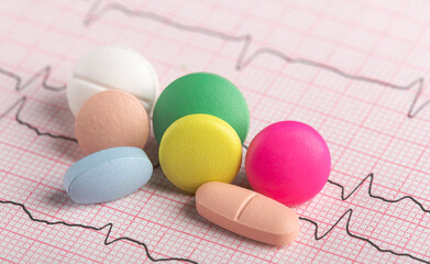 medical pills on the background of a cardiogram