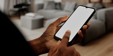 African-American Hand with smartphone in modern home, perfect for smart home app