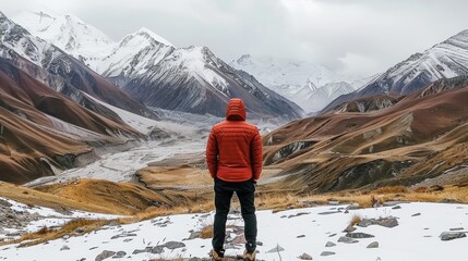 Person standing in front of snow mountains 