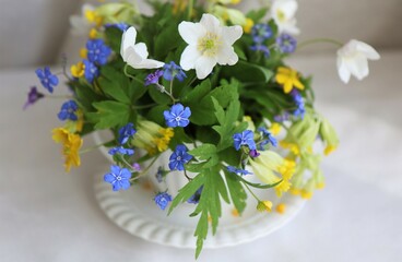 Bouquet of wildflowers in a white porcelain cup.