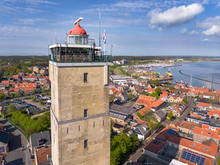 Aerial image of historic yellow brick lighthouse Brandaris on the Wadden island Terschelling in the...