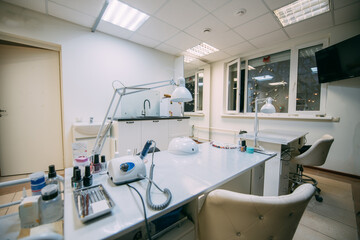 The interior of the nail salon without people. A bright, modern salon for the care of nails