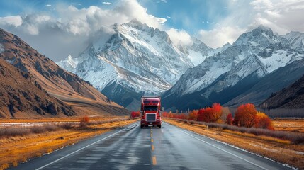A red semi truck drives through the mountains on a winding road.