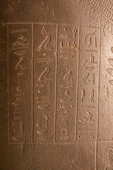 Egyptian hieroglyphs on a stone in a tomb close-up