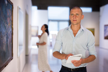 Middle aged man walking through the gallery