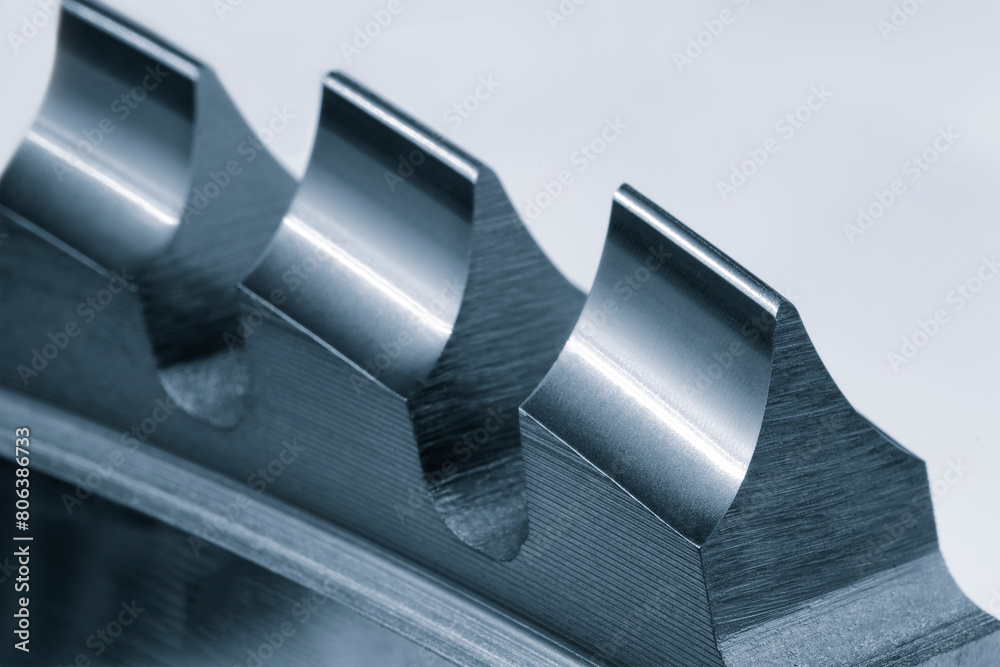 Poster a close up of a metal piece with three ridges. the ridges are sharp and pointy, giving the piece a s