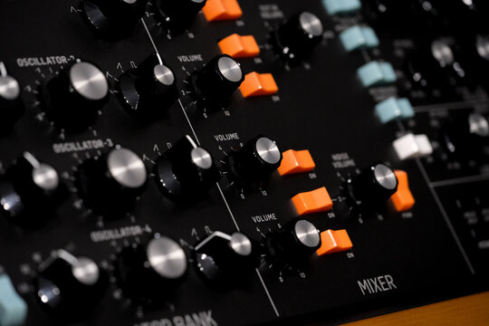 hardware music synthesizer , buttons and knobs of a vintage synth. Musical instrument, recording studio, studio gear, instruments close up, music