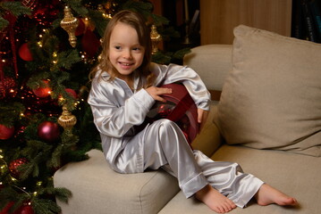 A happy family poses in pajamas in New Year's locations.